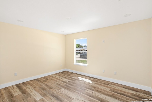 spare room with light hardwood / wood-style flooring