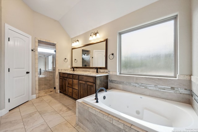 bathroom with vanity, lofted ceiling, and plus walk in shower