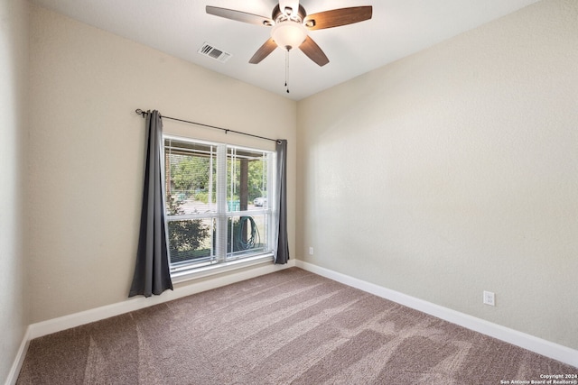 carpeted spare room featuring ceiling fan