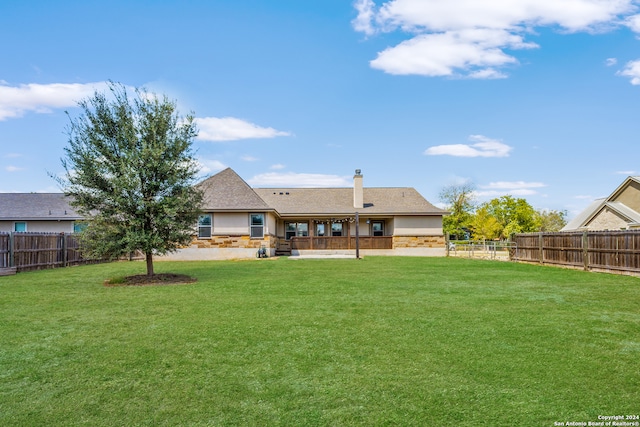 rear view of house with a patio area and a yard