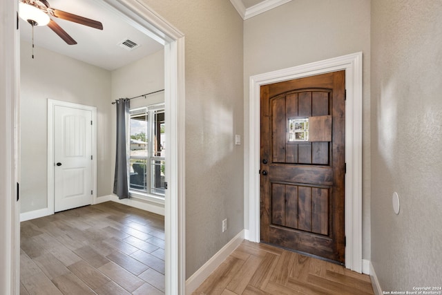 foyer with ceiling fan, light hardwood / wood-style flooring, and ornamental molding