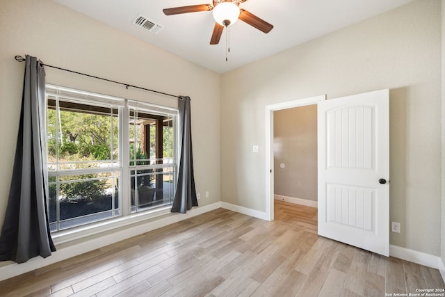 spare room featuring light hardwood / wood-style flooring and ceiling fan