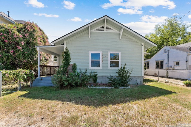 view of home's exterior featuring fence and a yard