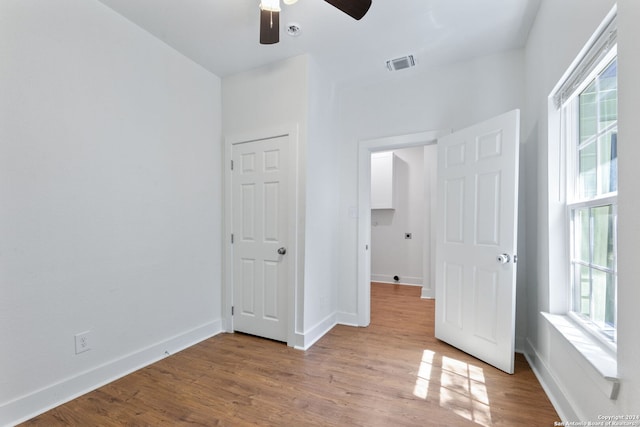 unfurnished bedroom with ceiling fan and light hardwood / wood-style floors