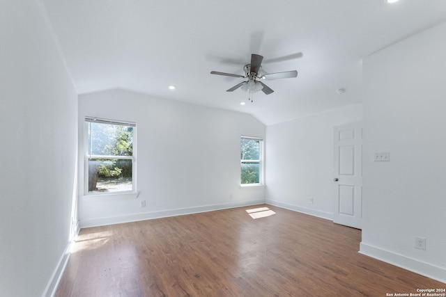 spare room featuring lofted ceiling, baseboards, and ceiling fan