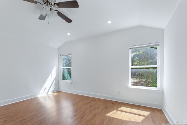 empty room with lofted ceiling, wood finished floors, and plenty of natural light