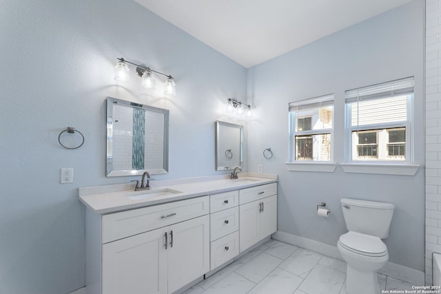 bathroom with walk in shower, vanity, and toilet