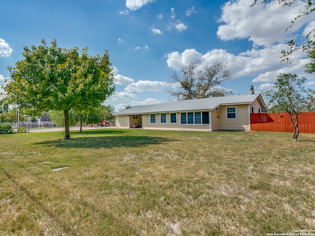 back of house featuring a yard