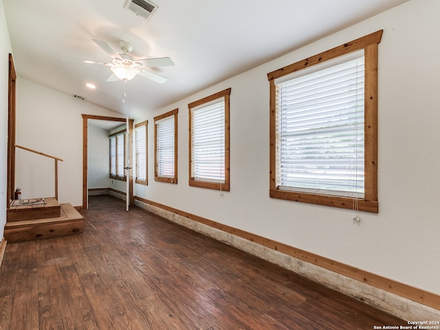 unfurnished room featuring ceiling fan, lofted ceiling, and dark hardwood / wood-style flooring