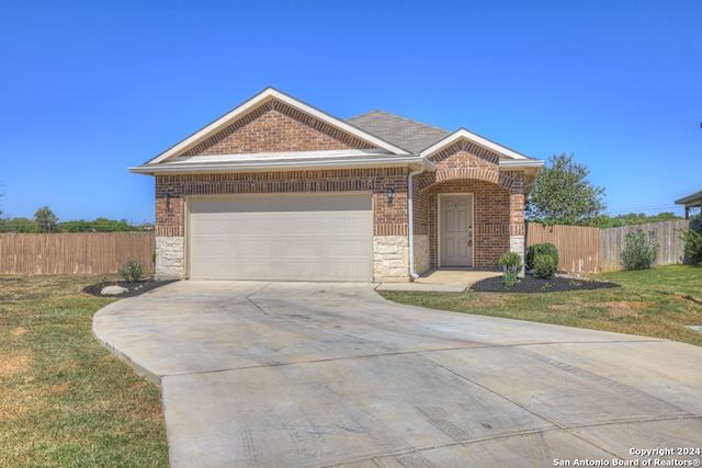 view of front of home featuring a garage and a front lawn