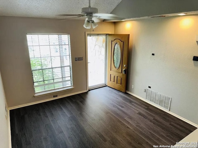 foyer featuring a textured ceiling, dark hardwood / wood-style flooring, and ceiling fan