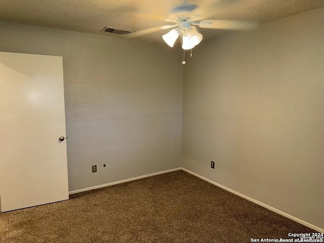 carpeted spare room with ceiling fan and a textured ceiling