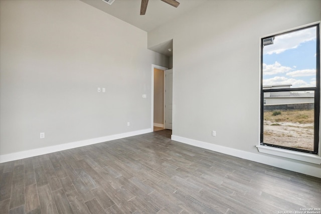 empty room featuring ceiling fan and hardwood / wood-style flooring