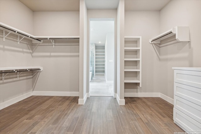 spacious closet with hardwood / wood-style floors