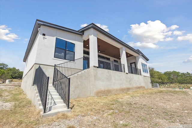 exterior space featuring cooling unit and ceiling fan