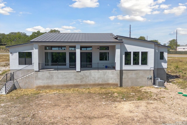 rear view of property featuring covered porch