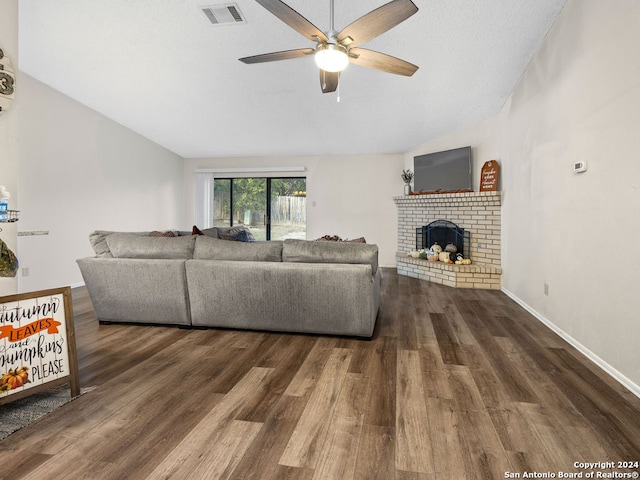 living room with ceiling fan, dark hardwood / wood-style floors, and a fireplace