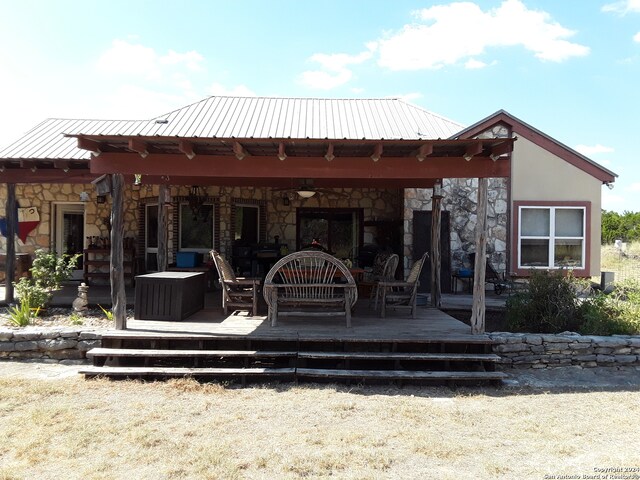 rear view of house featuring a deck