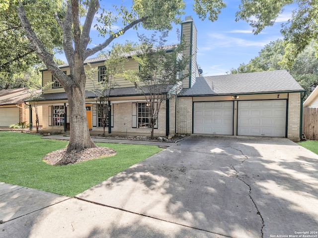 view of front property with a front yard and a garage