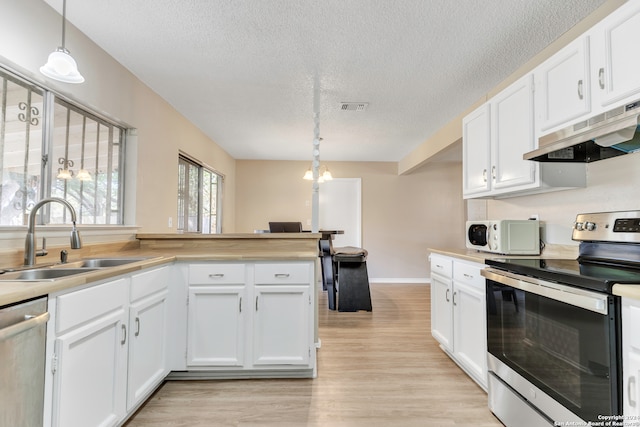 kitchen with pendant lighting, light wood-type flooring, sink, white cabinetry, and stainless steel appliances