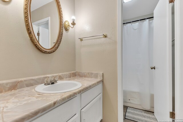 bathroom with vanity and shower / bath combo