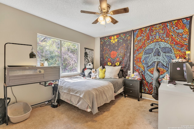 carpeted bedroom featuring ceiling fan and a textured ceiling