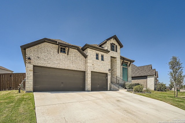 view of front of property with a garage and a front lawn