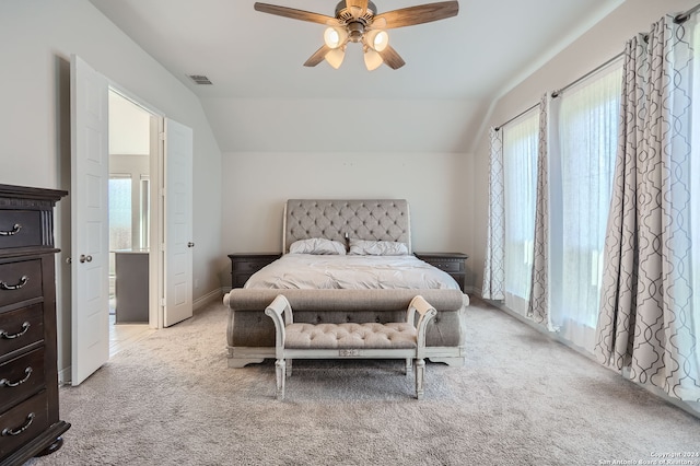 bedroom with ceiling fan, light colored carpet, and lofted ceiling