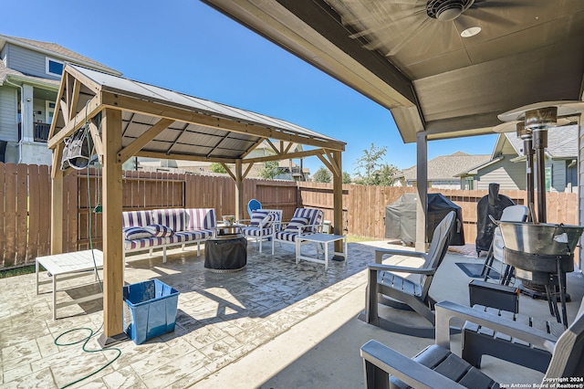 view of patio / terrace with ceiling fan, an outdoor living space, area for grilling, and a gazebo