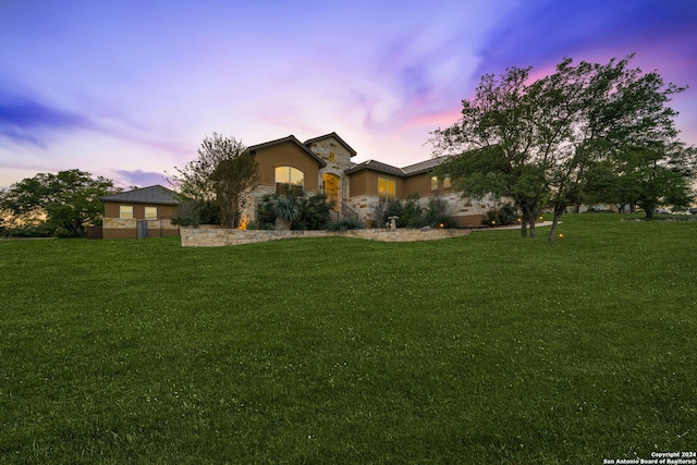 ranch-style house featuring a lawn