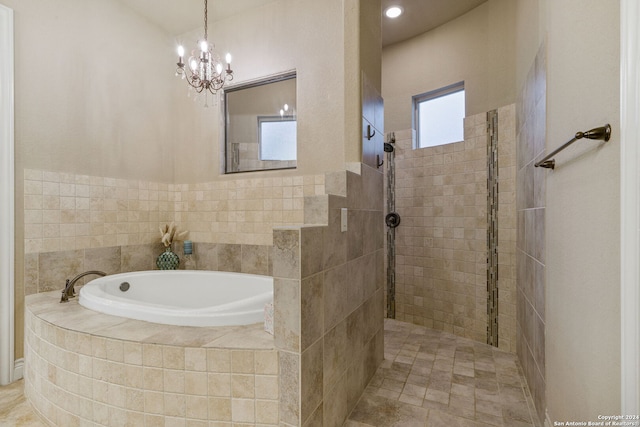 bathroom featuring separate shower and tub and a chandelier