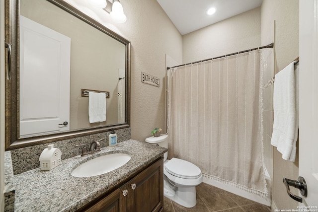 bathroom featuring tile patterned floors, walk in shower, vanity, and toilet