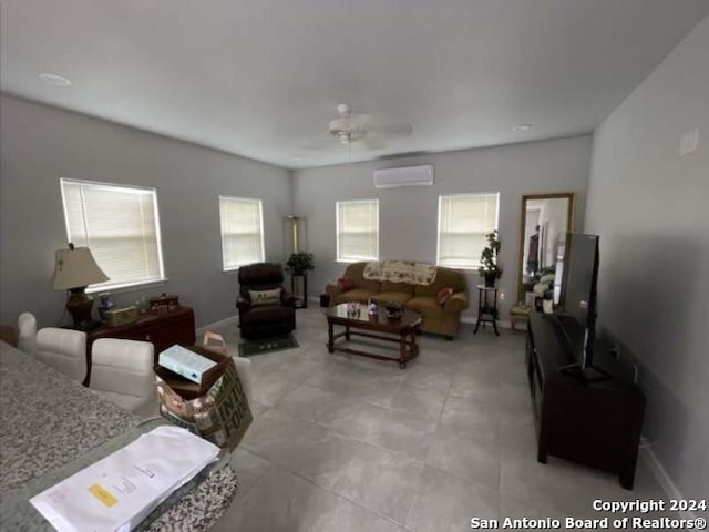 living room featuring ceiling fan and a wall mounted AC