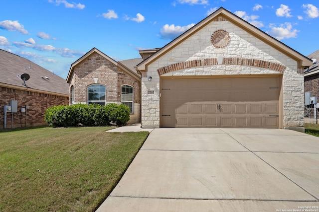 view of front of home with a garage and a front lawn