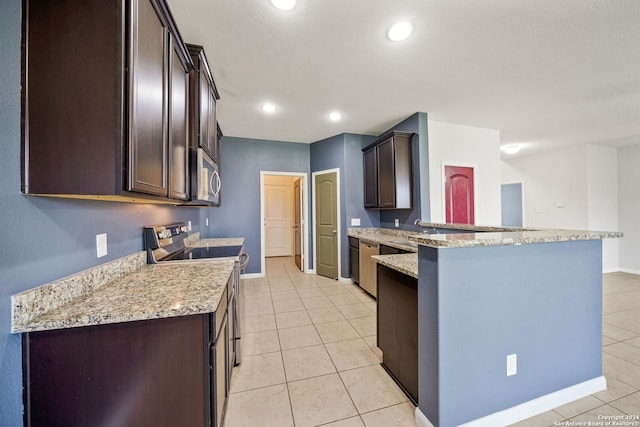 kitchen featuring light stone counters, light tile patterned floors, stainless steel appliances, and kitchen peninsula