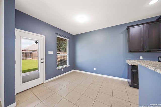 unfurnished dining area with light tile patterned floors