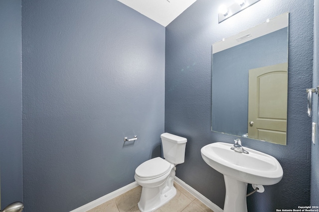 bathroom featuring lofted ceiling, toilet, and tile patterned floors