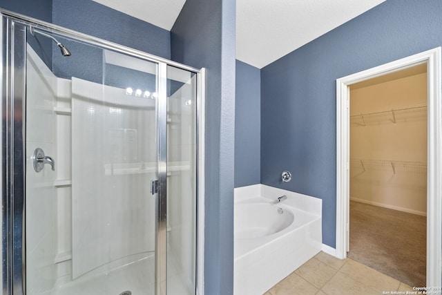 bathroom featuring tile patterned floors and separate shower and tub