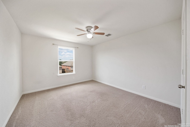 carpeted spare room with ceiling fan