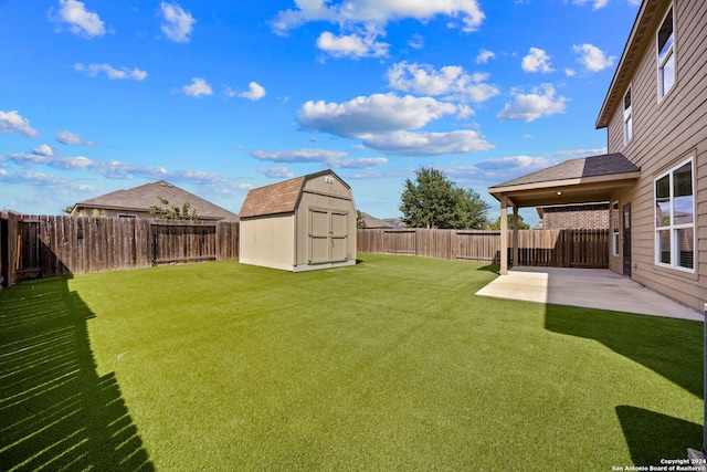 view of yard featuring a storage shed and a patio area