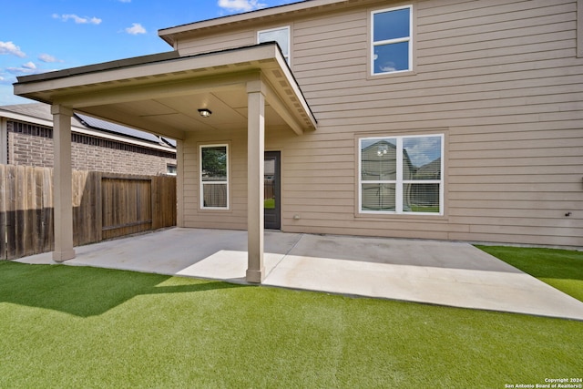 back of house with a yard and a patio area