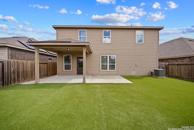 rear view of house featuring a yard, a patio area, and central AC