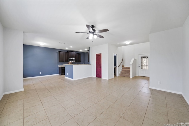 unfurnished living room featuring ceiling fan and light tile patterned flooring