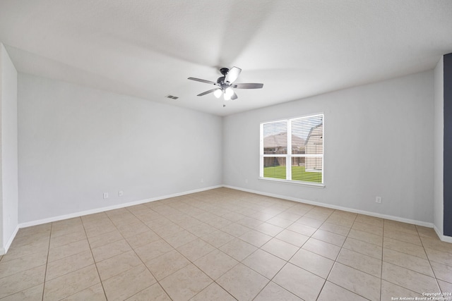 spare room featuring light tile patterned floors and ceiling fan