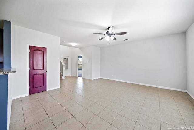 unfurnished living room with ceiling fan and light tile patterned flooring