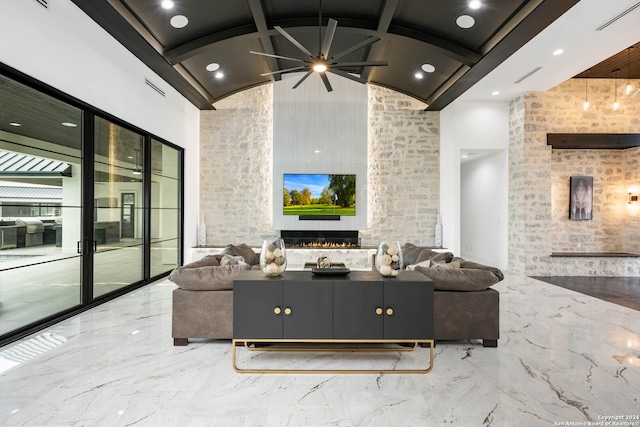 living room featuring a fireplace, beam ceiling, ceiling fan, and high vaulted ceiling