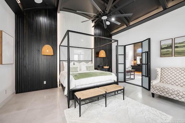 bedroom featuring ceiling fan, wooden walls, beam ceiling, and high vaulted ceiling