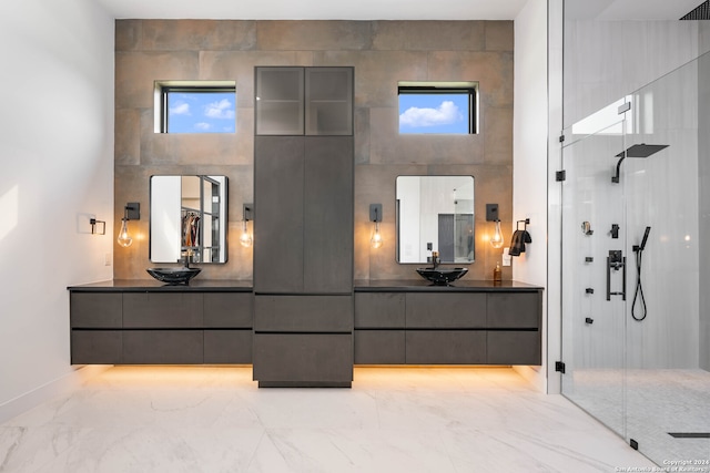 bathroom with walk in shower, vanity, and a wealth of natural light