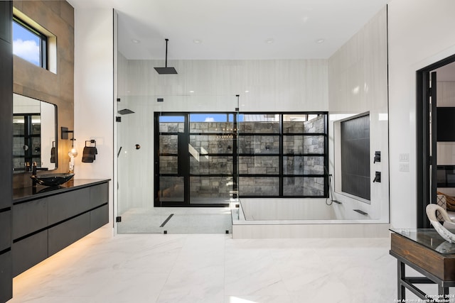 bathroom featuring vanity and separate shower and tub