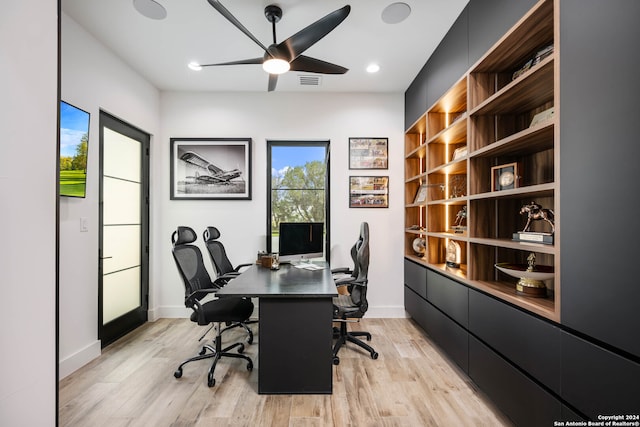 office featuring light hardwood / wood-style floors and ceiling fan